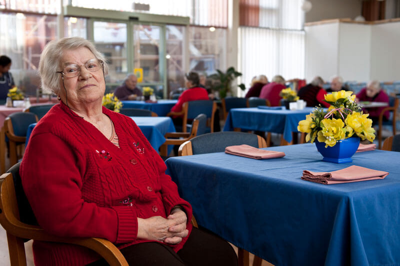 Lady sittign in dining room at Kalyna Care