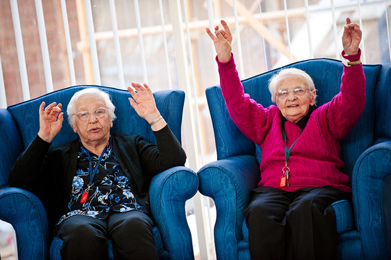 Two ladies with their arms up at Kalyna Care
