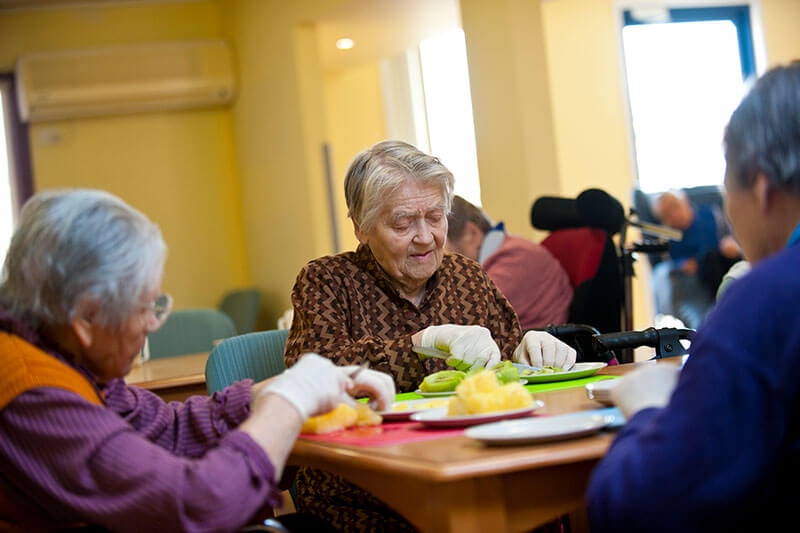 Ladies cutting as an activity at Kalyna Care