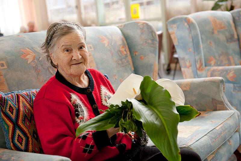 Lady with large lily at Kalyna Care