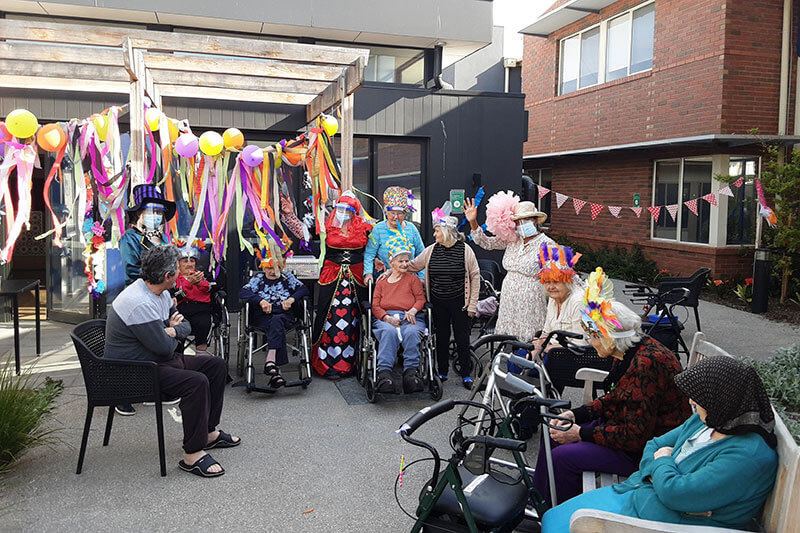 Party outdoors at Kalyna Care with fun hats