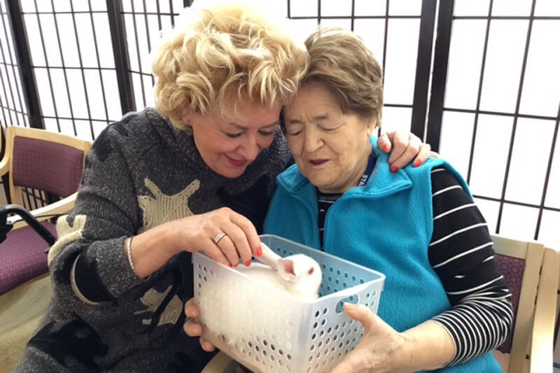 Two ladiesholding a bunny at Kalyna Care