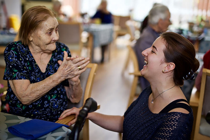 Lady and carer laughing at Kalyna Care