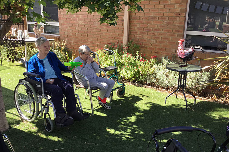 Two ladies with water pistols at Kalyna Care